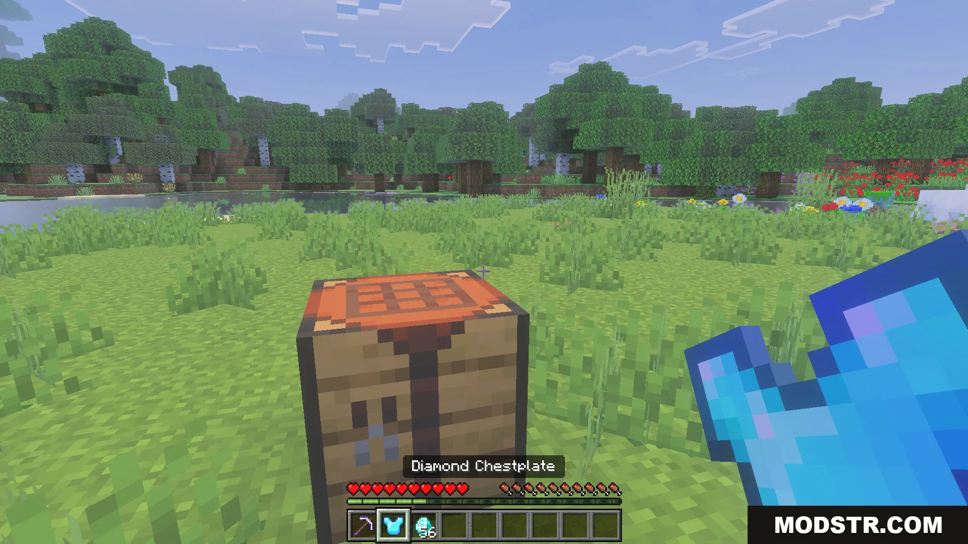 Auto Enchant Addon Screenshot 5 Minecraft player holding a diamond chestplate in front of a crafting table