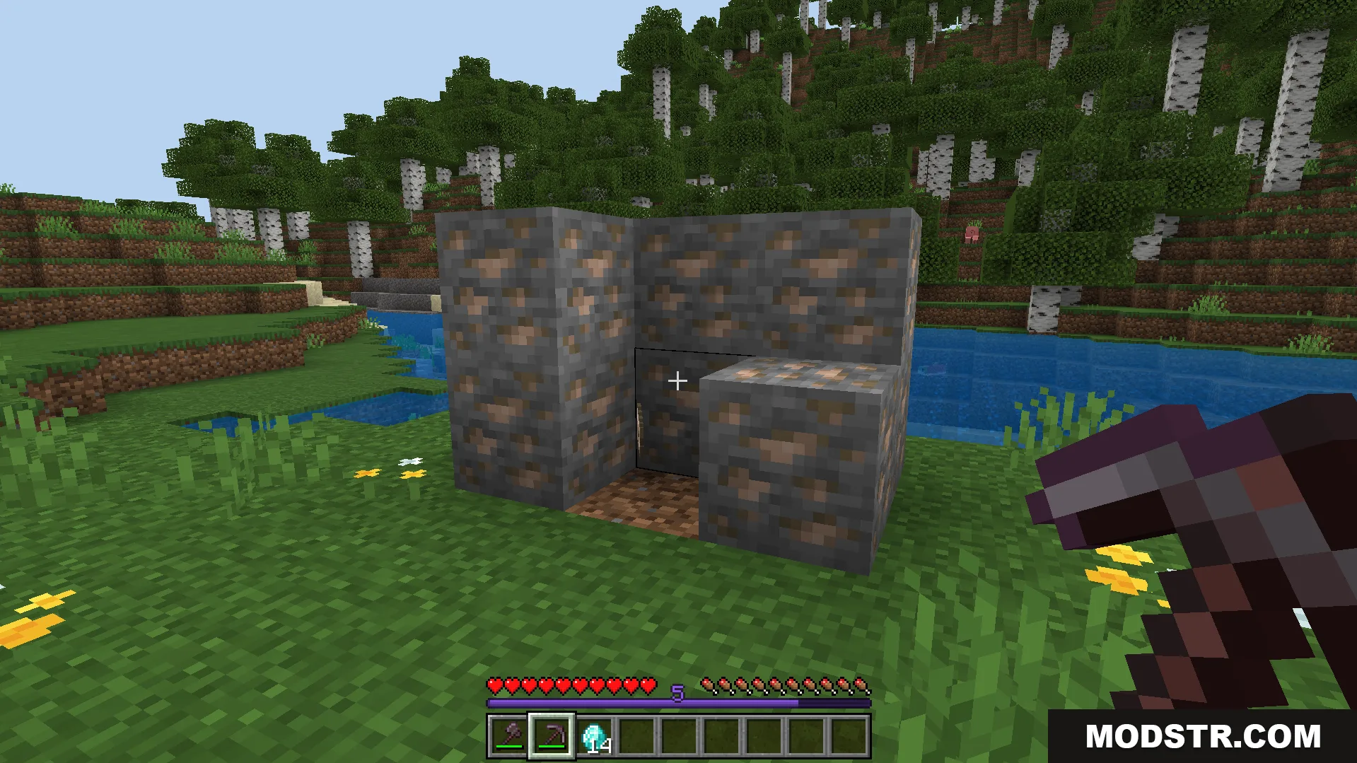 Player preparing to mine a cluster of iron ore blocks with a pickaxe