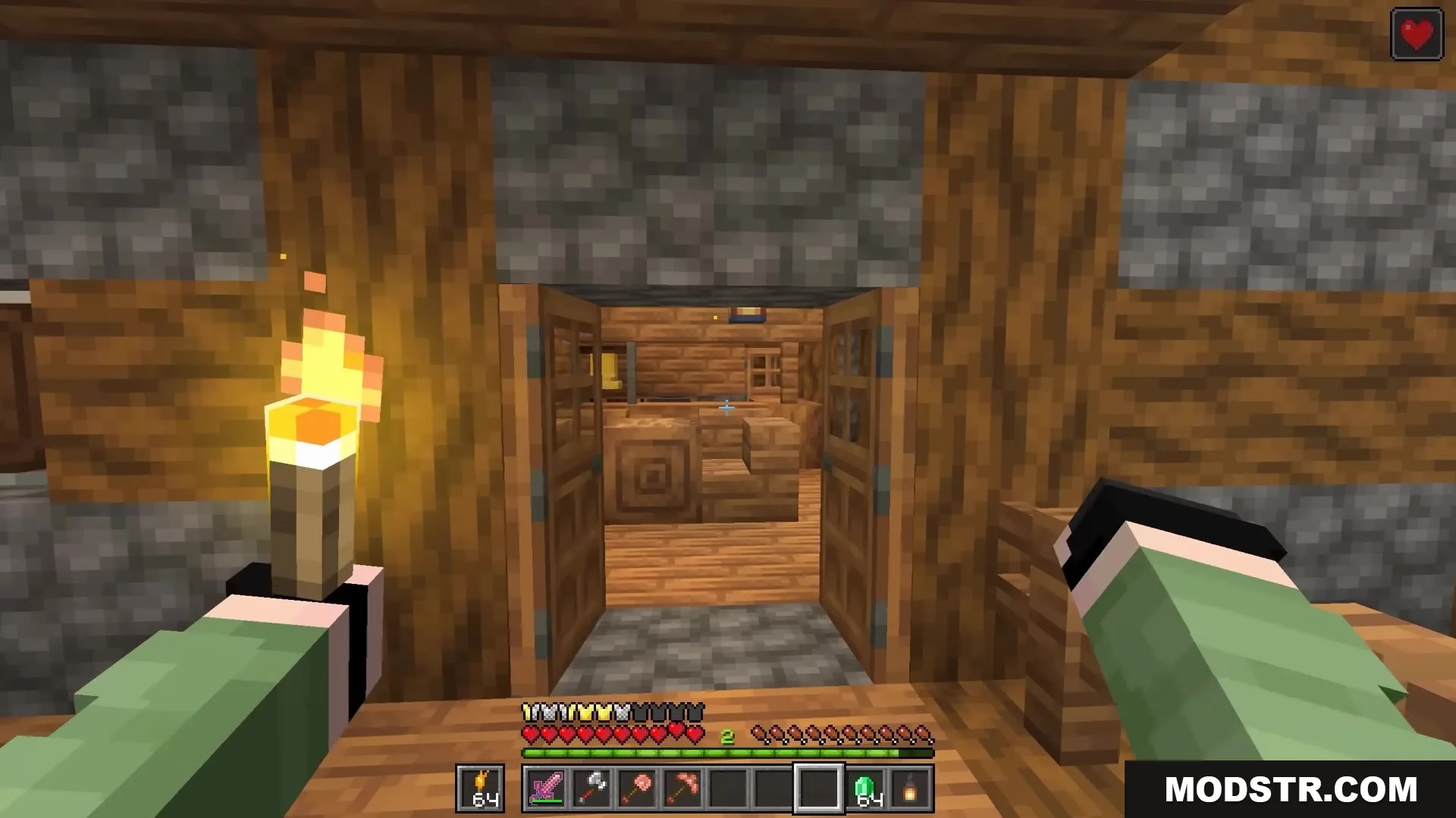 Bits and Balance Mod Screenshot 10 A player holds a torch while looking through open doors inside a house
