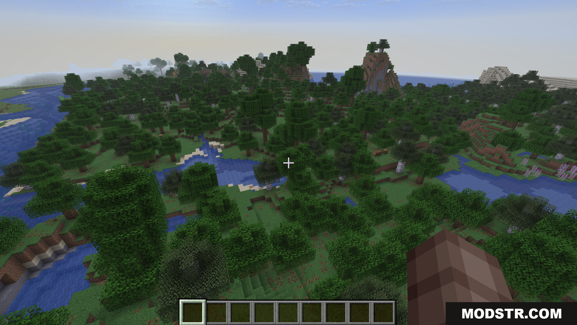 Player flying over a dense forest and river landscape