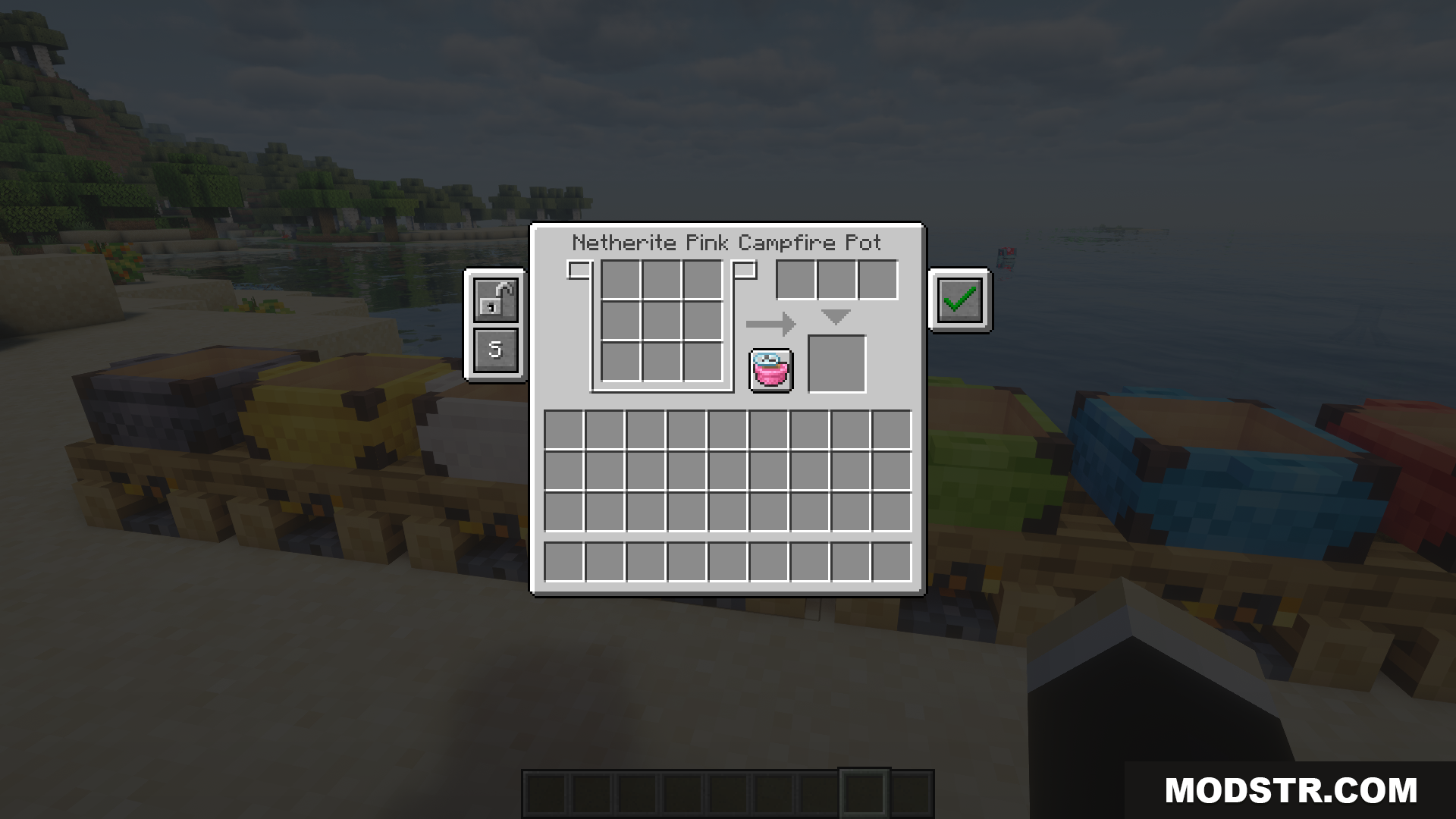 Various colored campfire pots placed on wooden blocks near water
