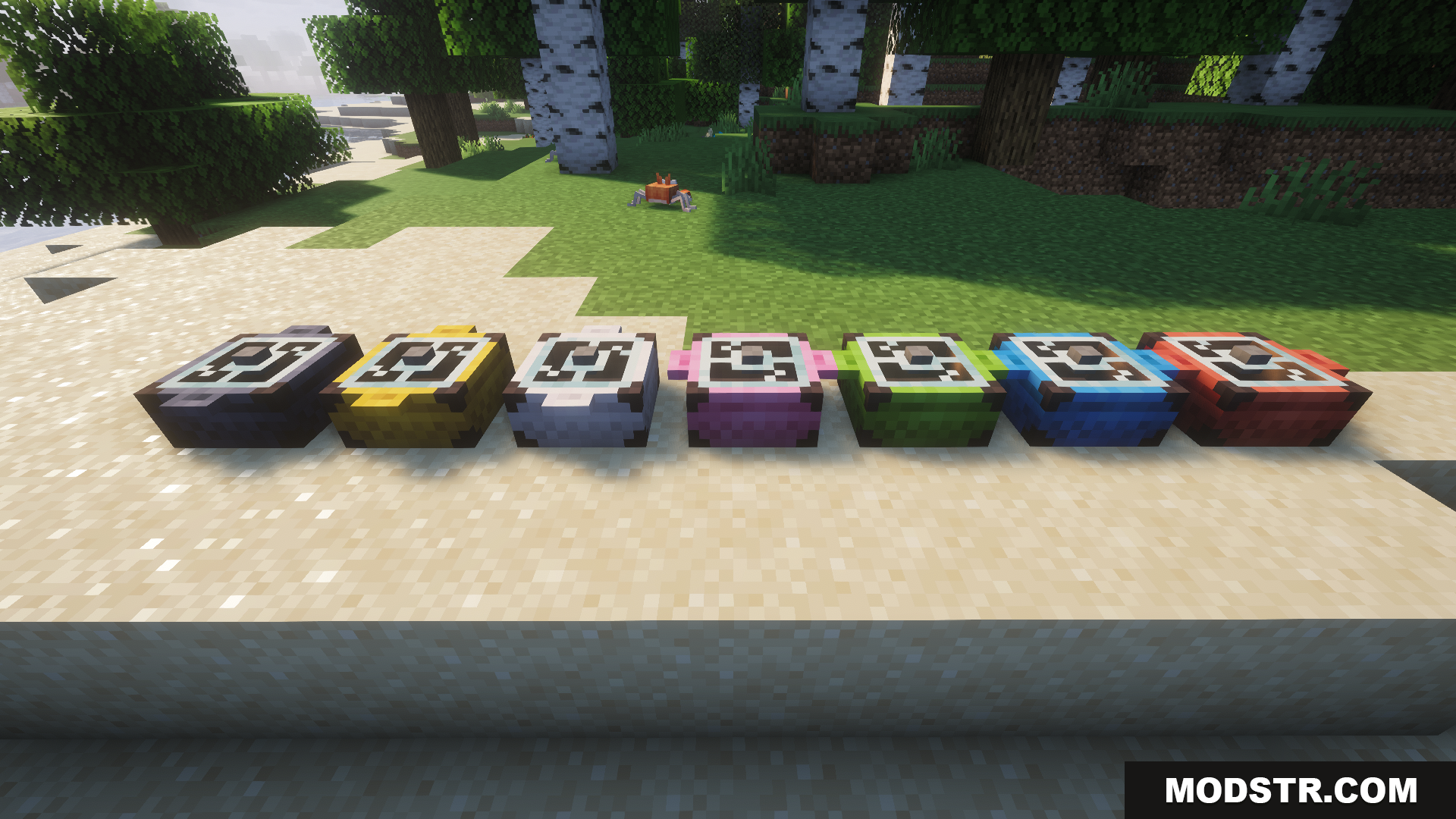 Several different colored campfire pots placed on the sandy beach