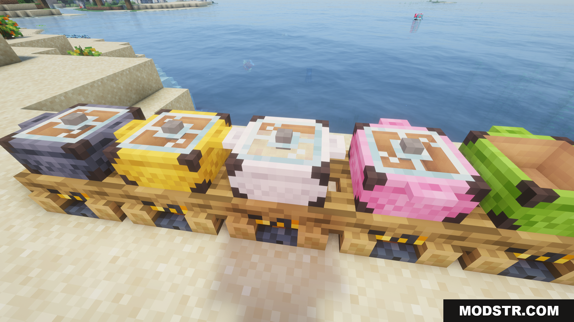 Various colored campfire pots placed on campfires along a sandy beach