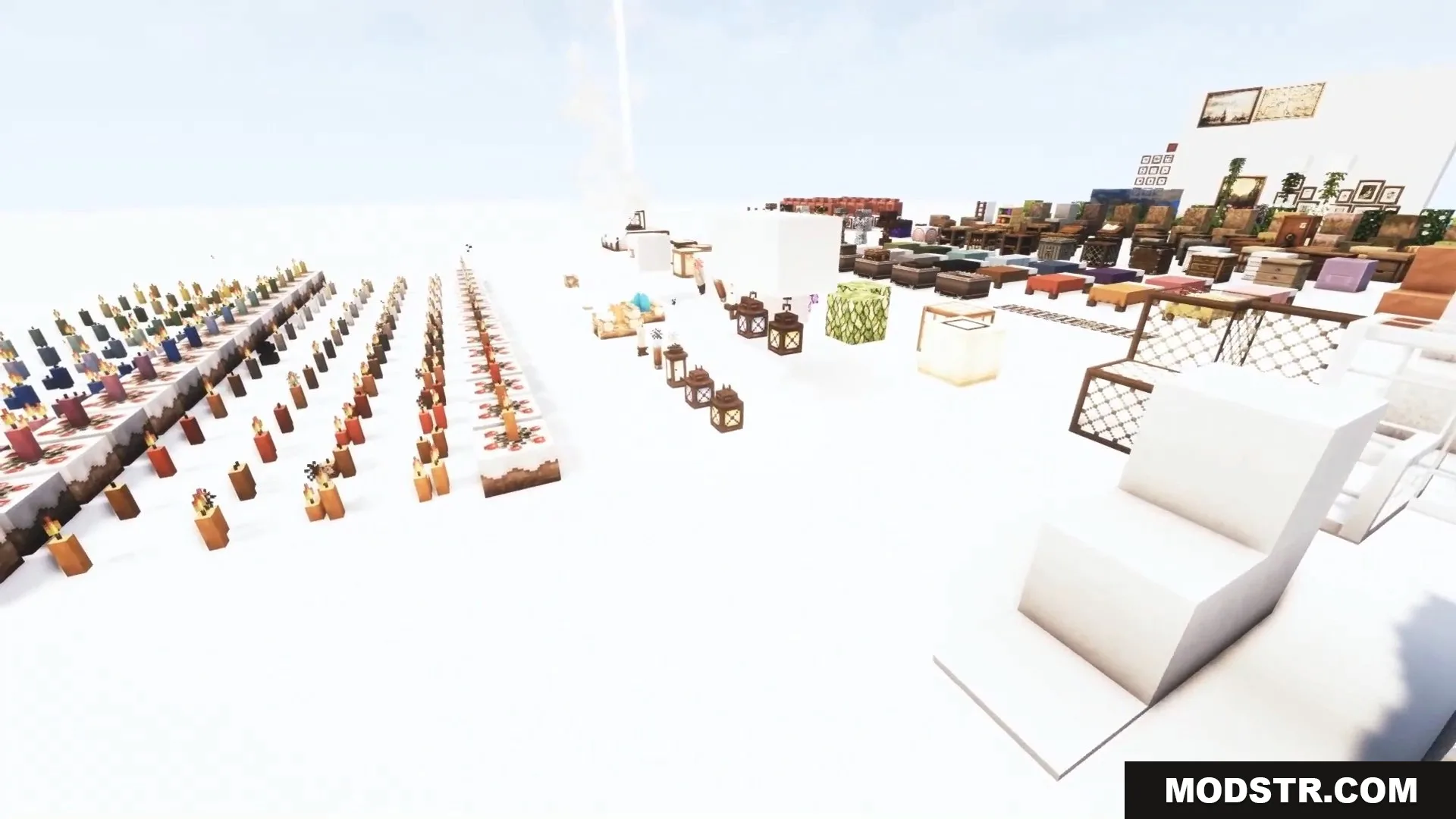 A wide selection of detailed candles and lanterns displayed on a white floor.