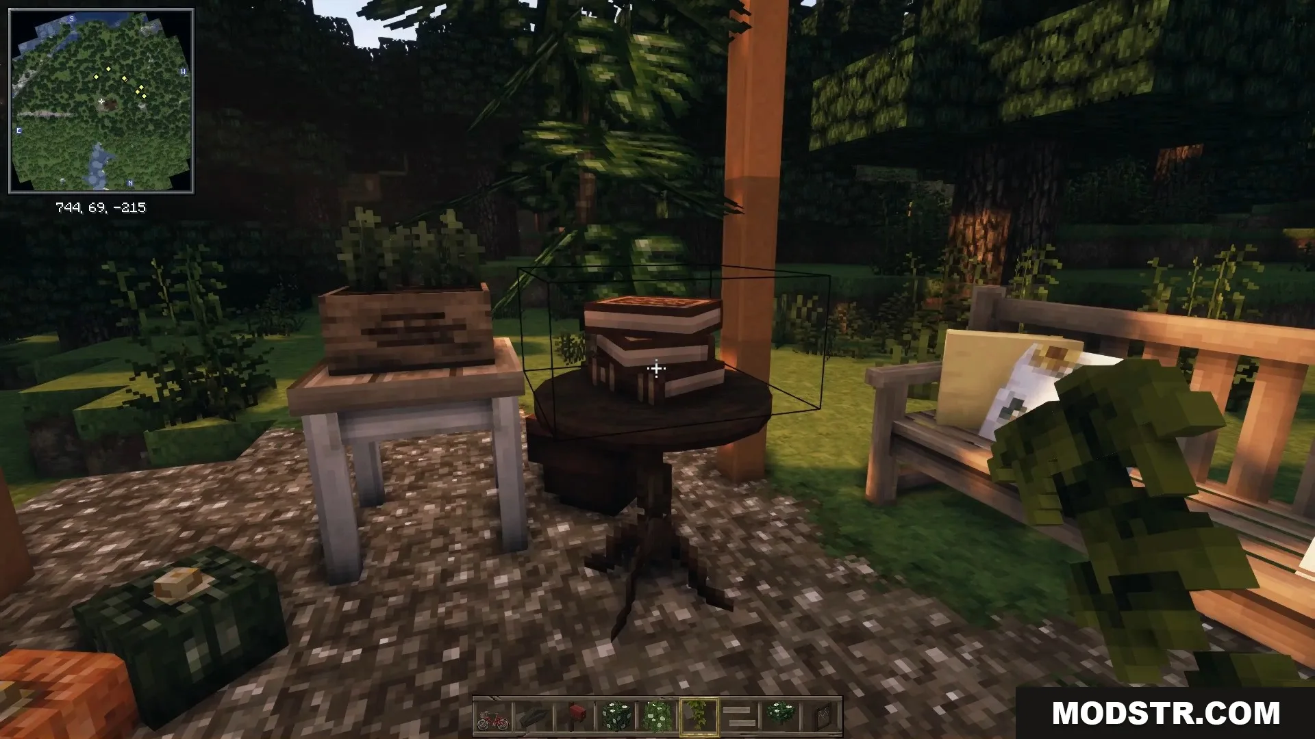 A peaceful garden seating area with a wooden bench, small table, and books.