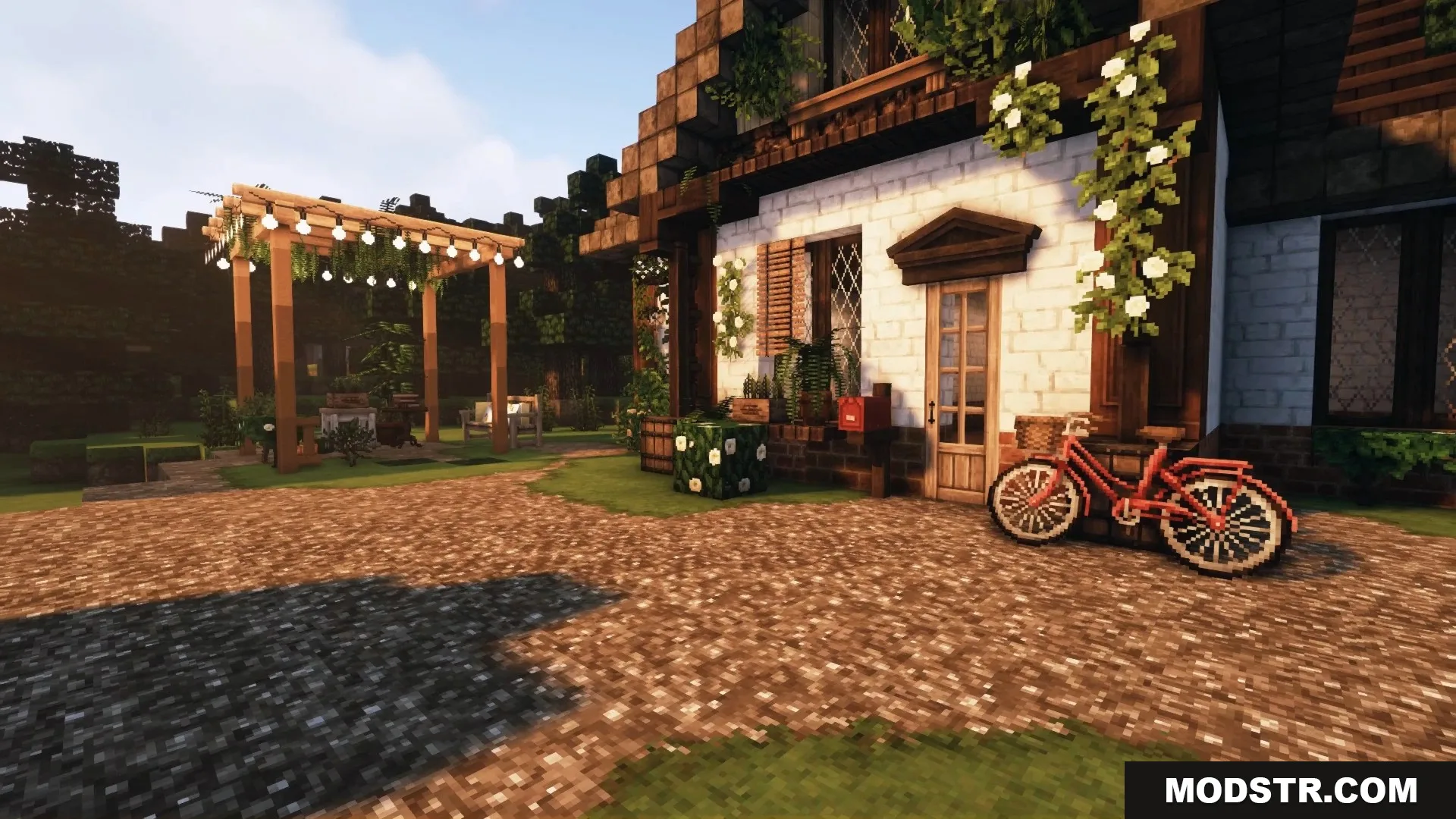 A charming cottage exterior featuring a red bicycle and a lovely garden pergola.