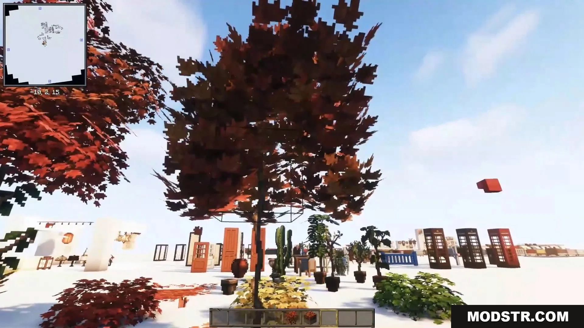 Beautiful autumn trees and potted plants stand near classic red telephone booths.