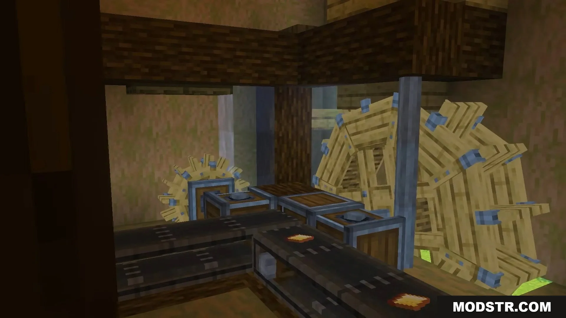 A complex machine setup featuring large wooden water wheels and conveyor belts