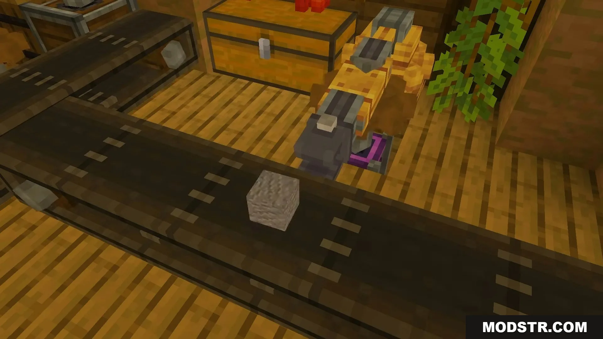 Mechanical arm interacting with a stone block on a conveyor belt near chests