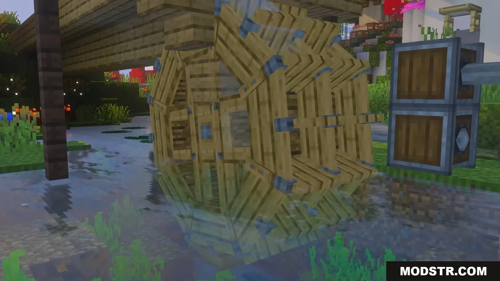 Large wooden water wheel structure placed in a shallow river generating power