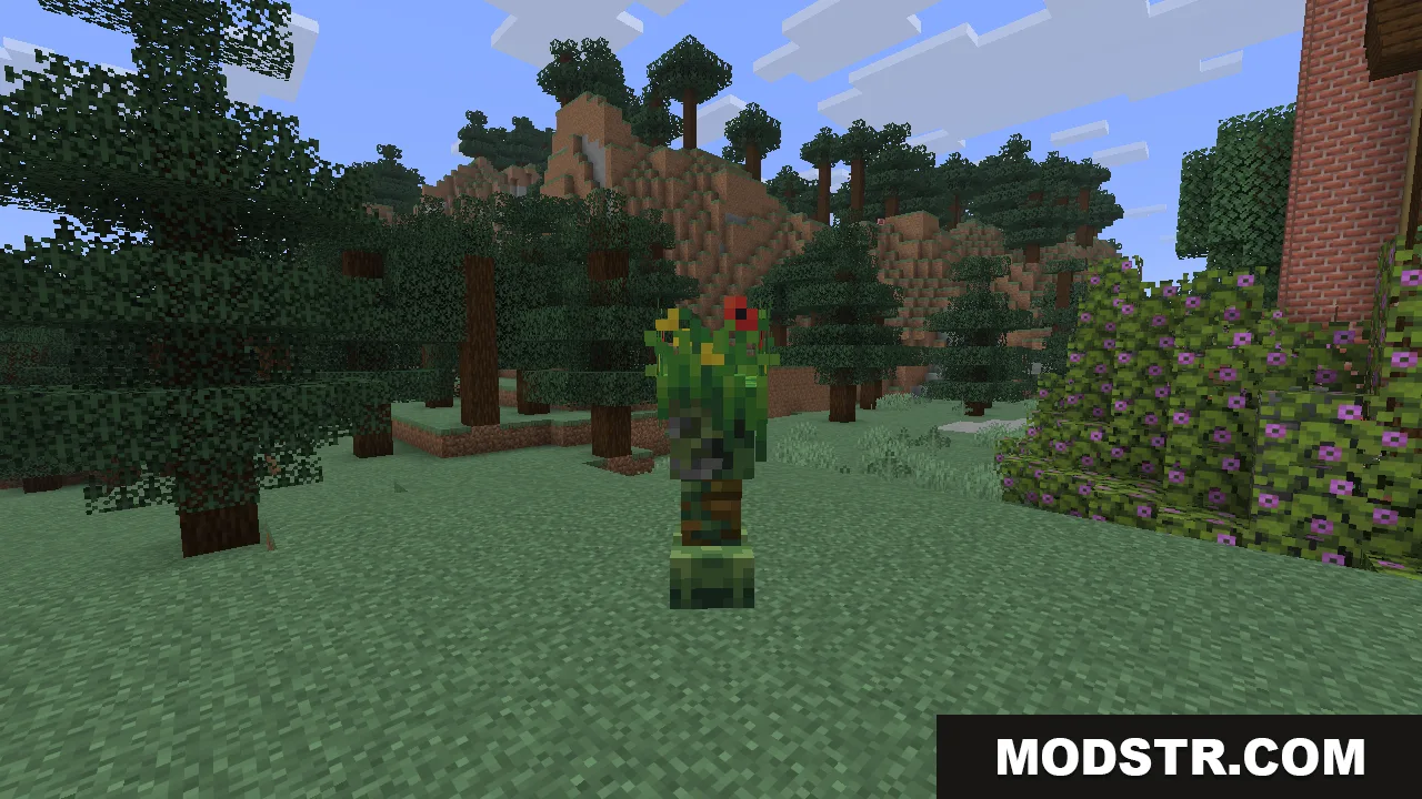 A close-up of the jungle creeper, its body wrapped in green leaves and dotted with small red and yellow flowers