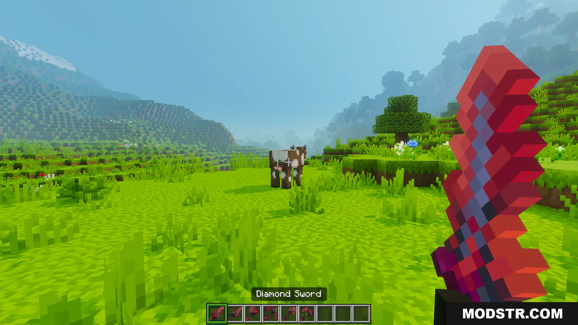 A player holds a red diamond sword in a grassy field