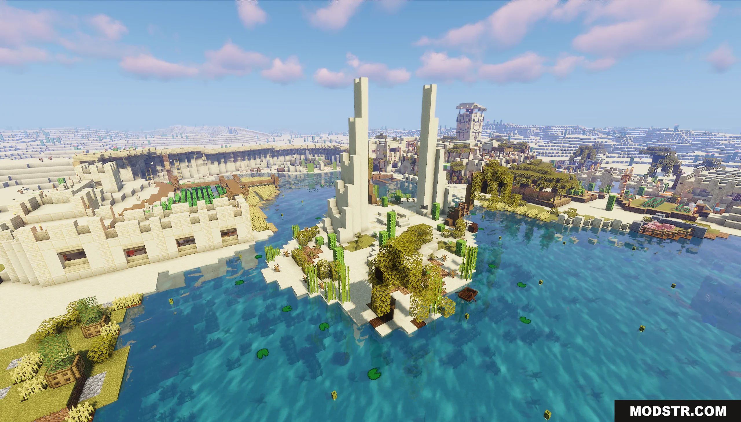 Two tall white pillars stand on a small island in a desert oasis