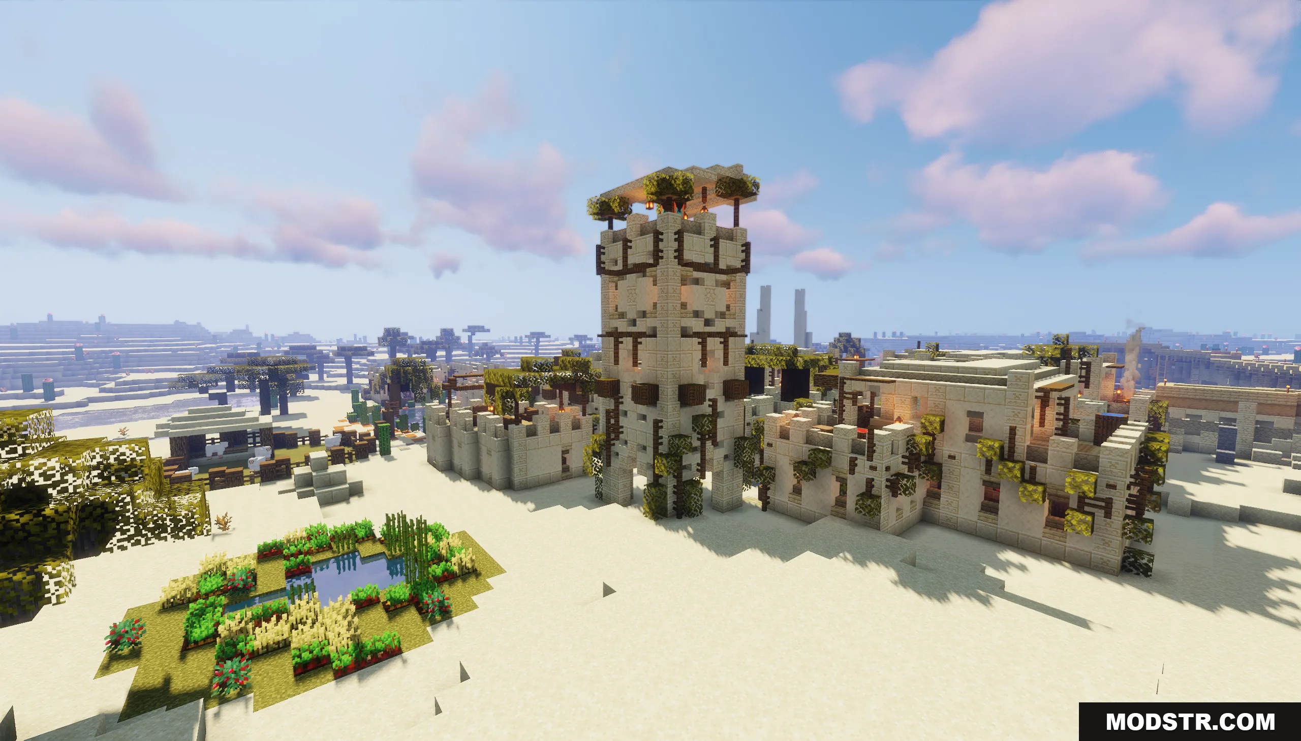 Tall sandstone tower overlooking a desert village with small farms and buildings