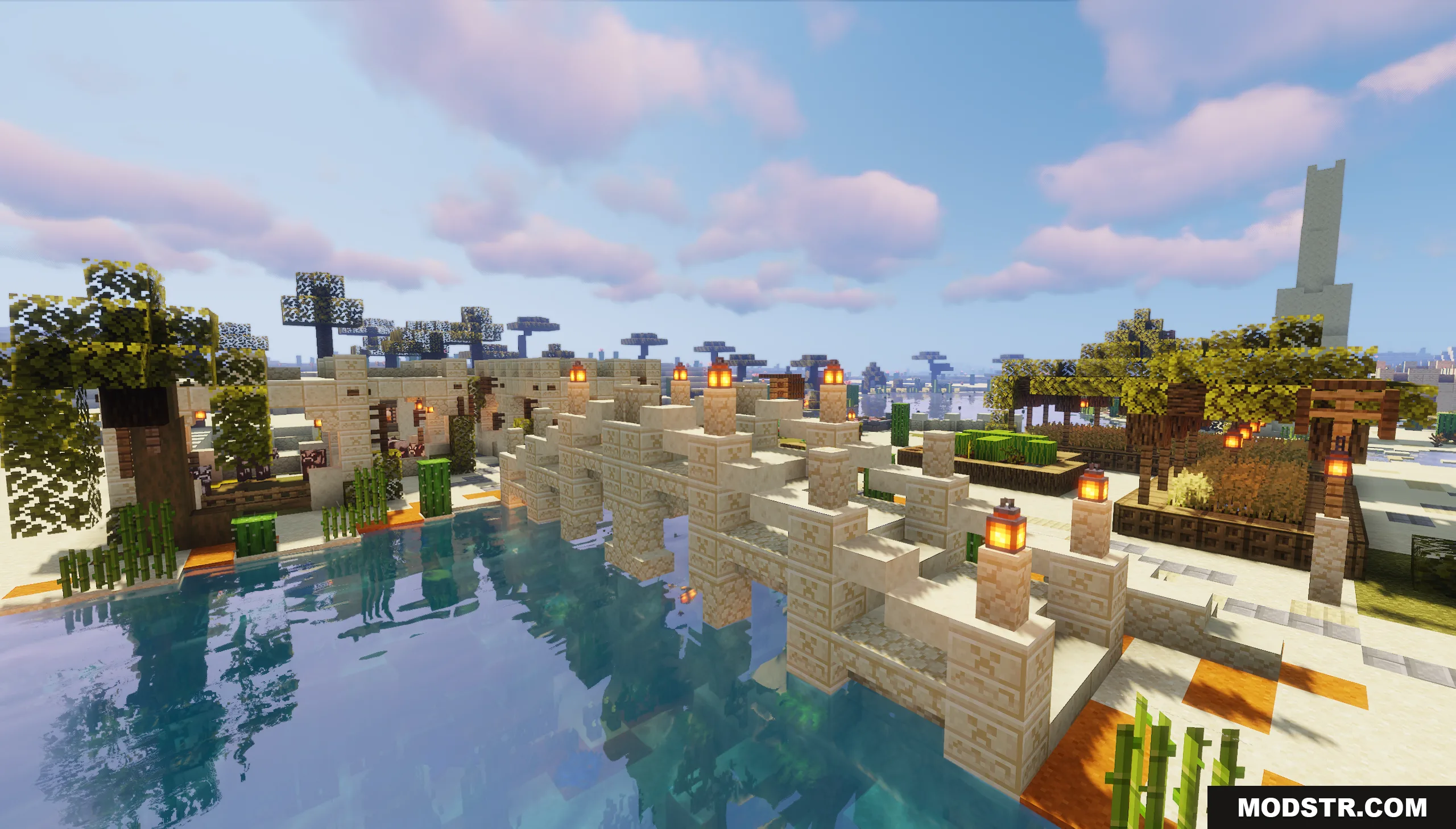 Sandstone bridge with lanterns crossing a river in a desert oasis