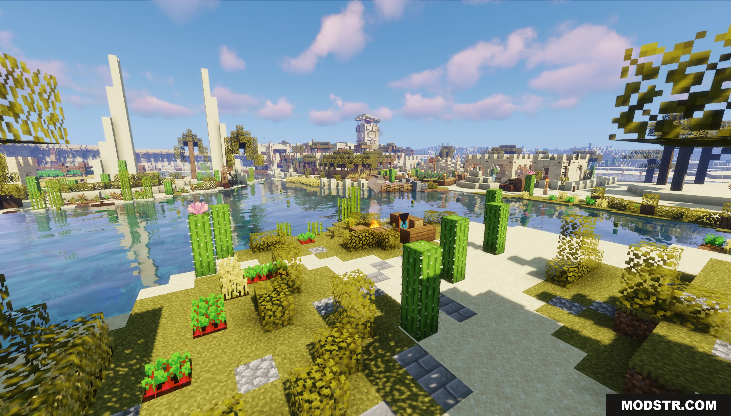 Lush greenery and water surrounding a desert settlement under a bright sky