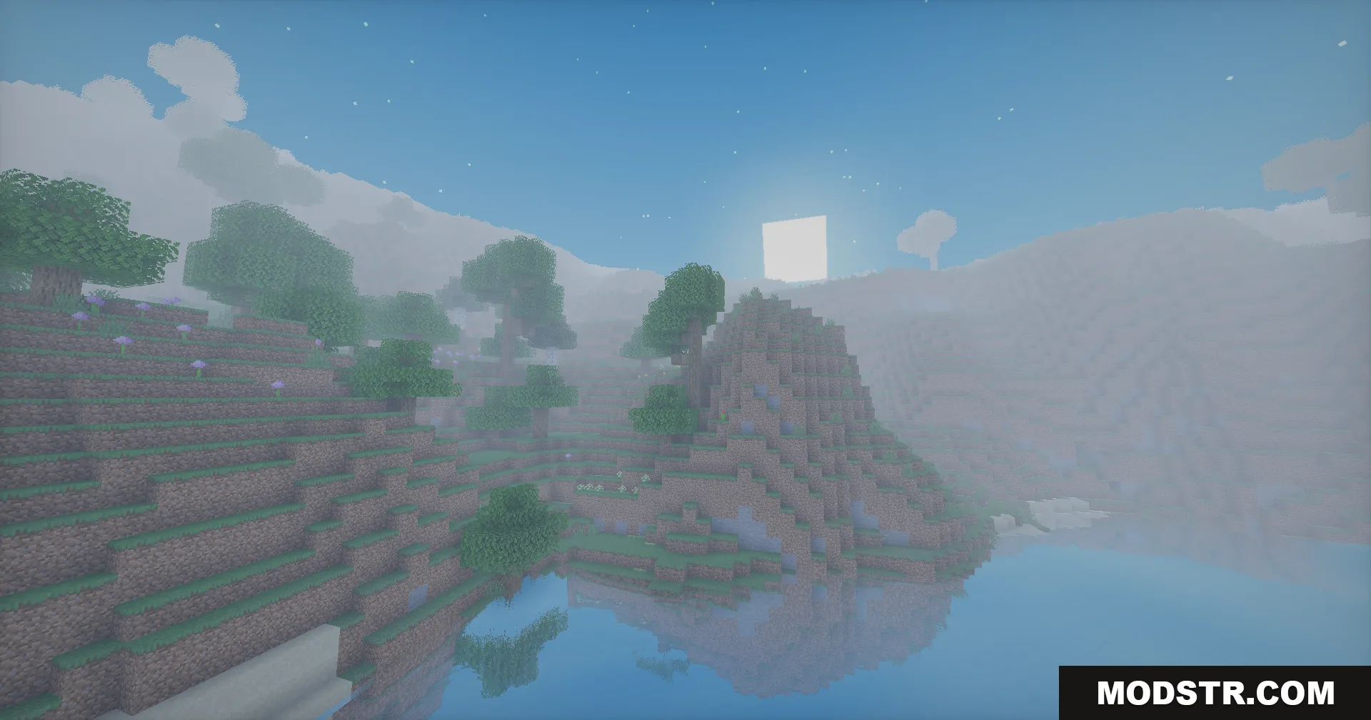 Soft lighting and reflections enhance the view of a peaceful lake and mountain