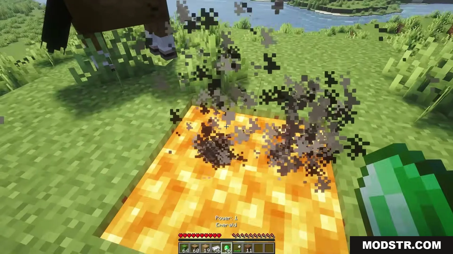 Eating Animations Mod Screenshot 9 Player holding an emerald item near a glowing orange block with smoke particles