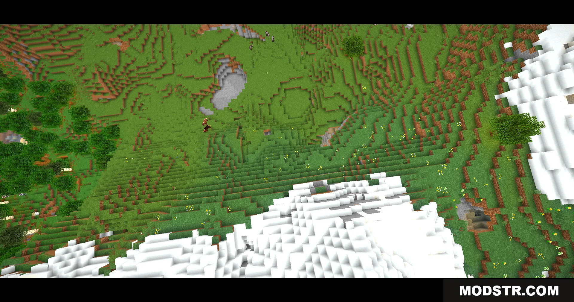 Top down view of a green valley and snowy hills with cinematic bars