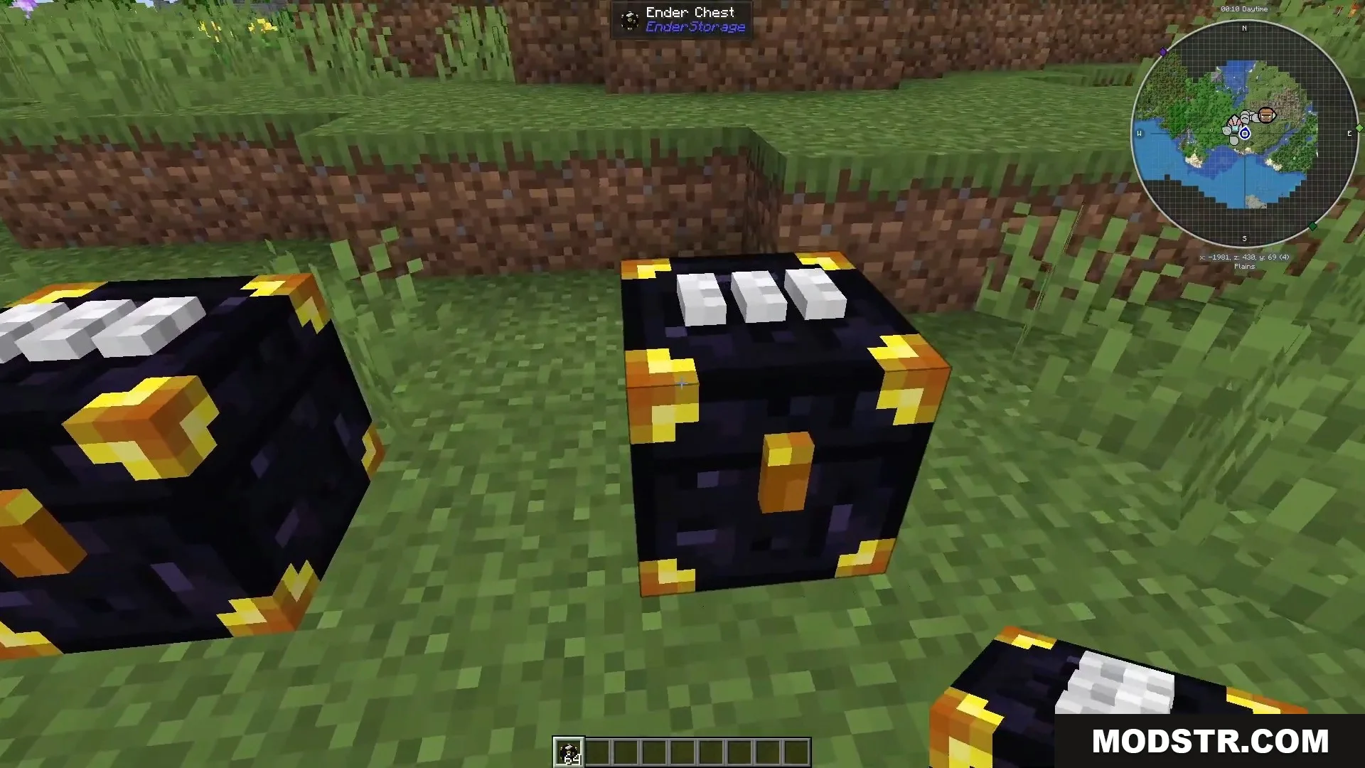 Three color coded Ender Chests placed on a grassy field in Minecraft