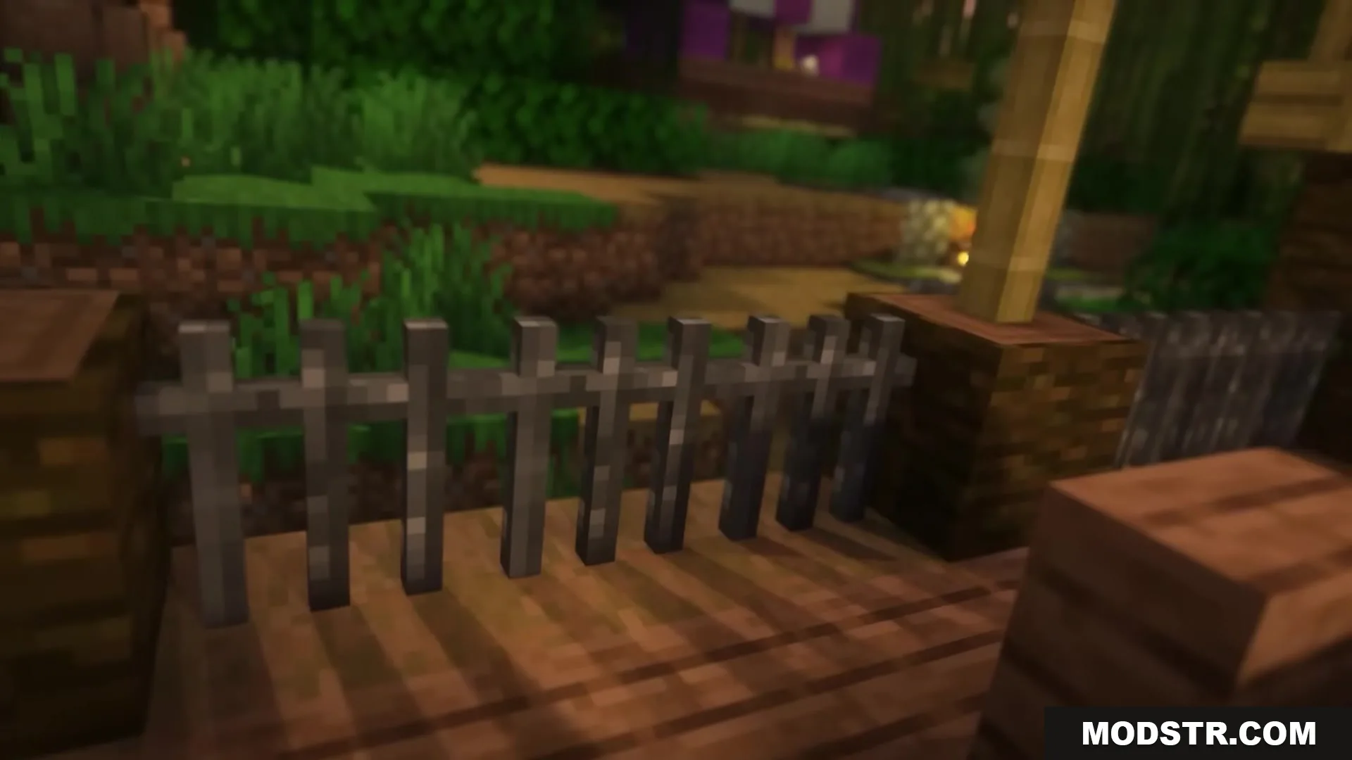 Enhanced Audio Ambience Sound Pack Resource Pack Screenshot 1 A dark wooden fence surrounded by lush green grass and trees