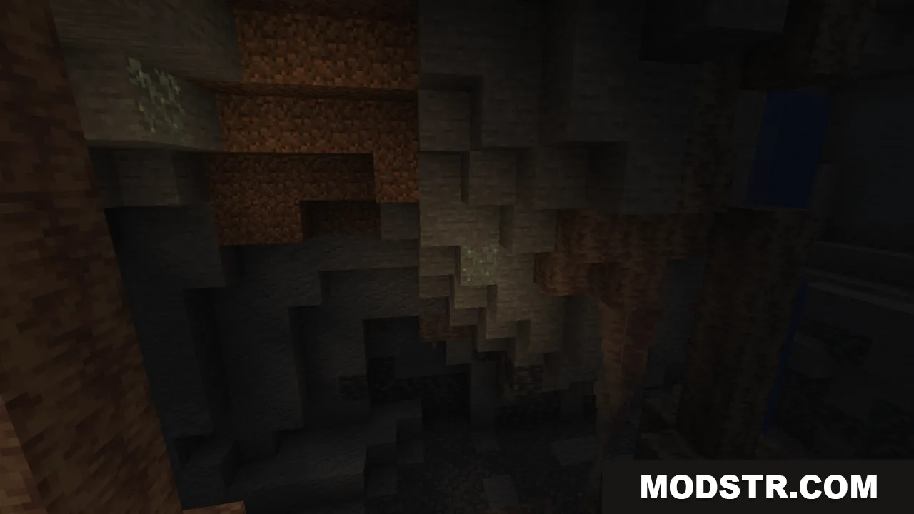 Jagged rock formations and deep shadows inside a dim Minecraft cavern