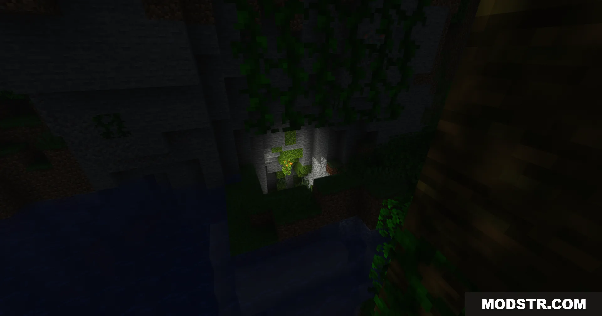 GlamorousSP Shaders displays a dark cave entrance with hanging green vines