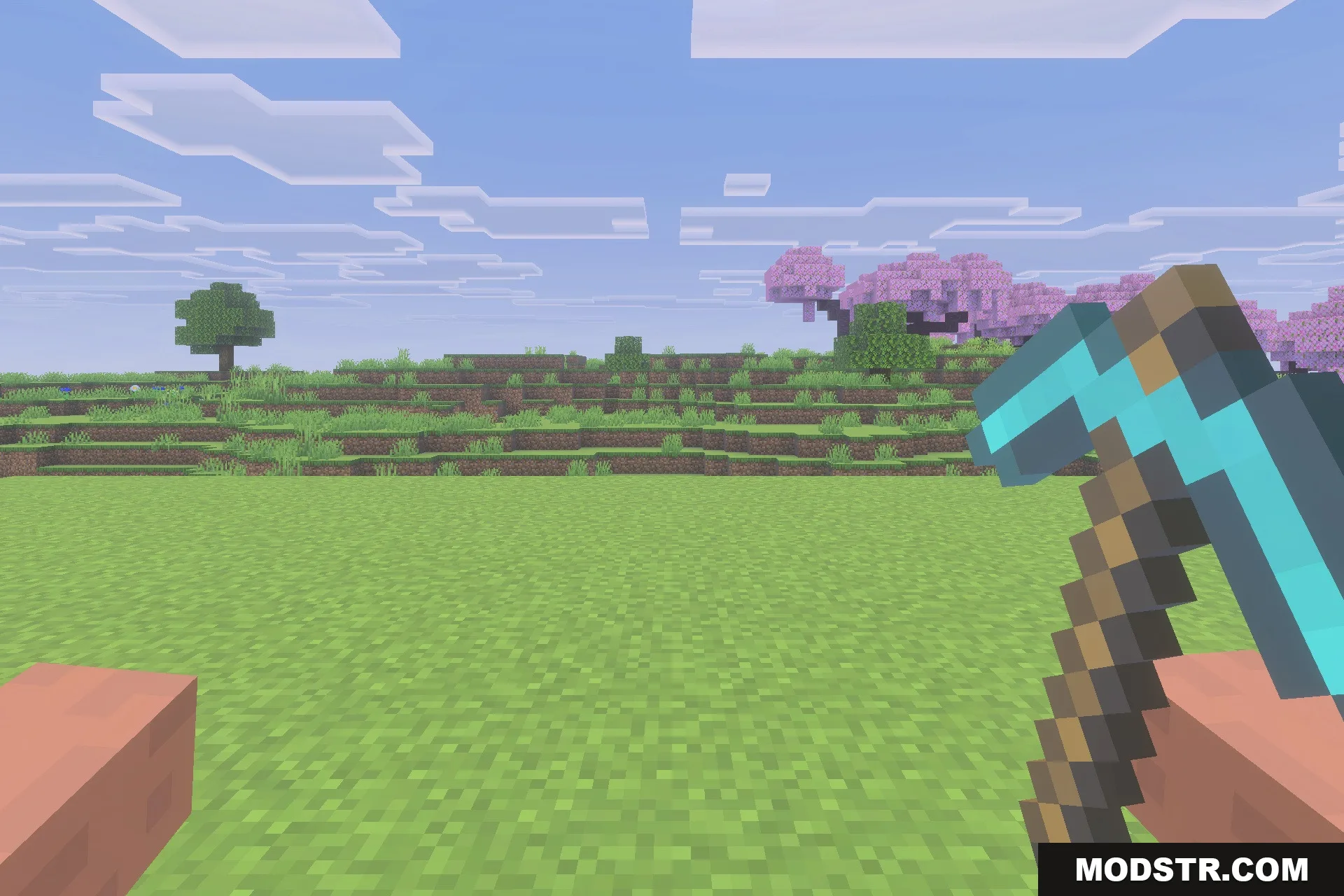 Hold My Items Bedrock Texture Pack Screenshot 4 A player holding a diamond pickaxe while looking at a cherry blossom forest