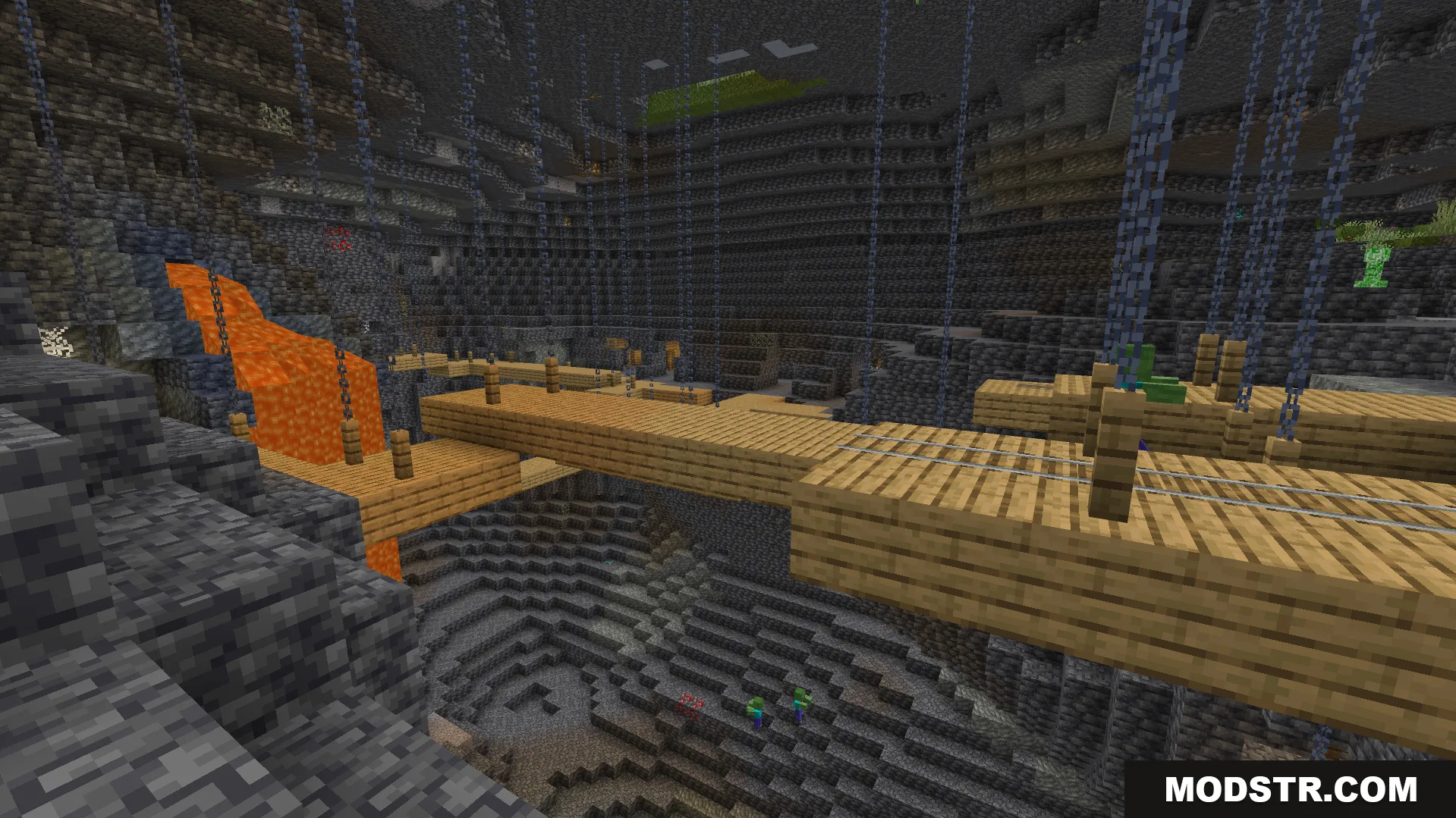 fully illuminated underground ravine with hanging wooden mineshaft bridges and lava falls
