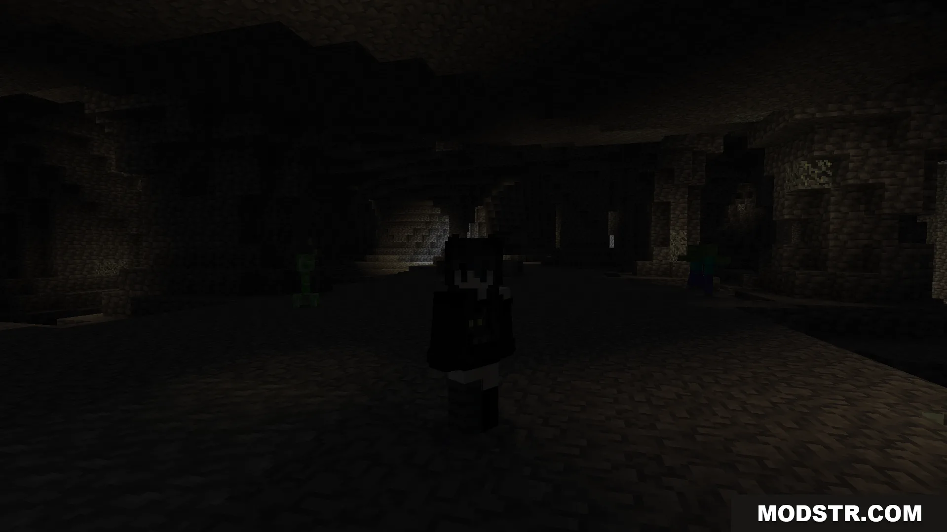 Player character standing in a dark cave near a creeper and a zombie
