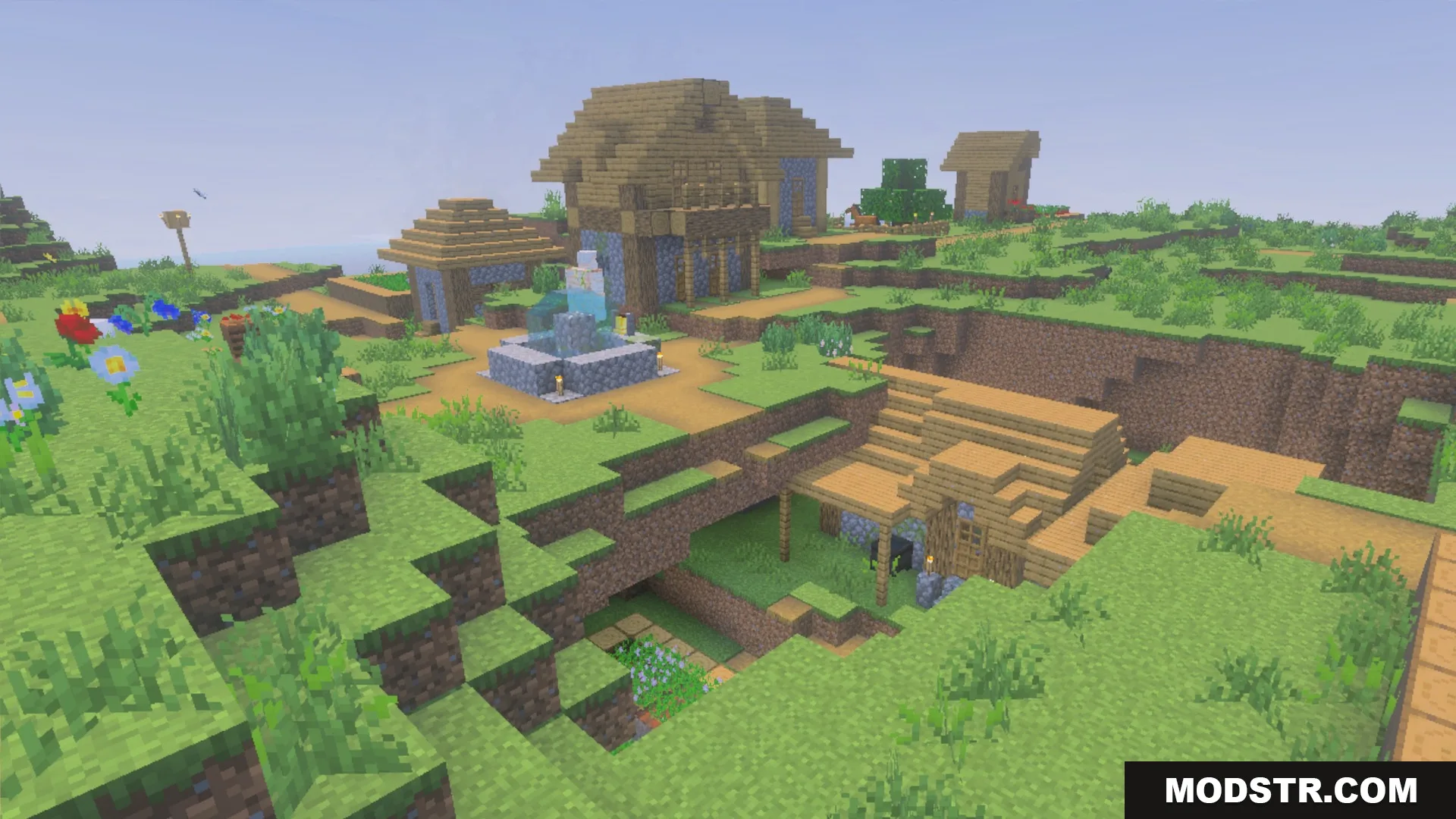 Village buildings and a fountain in daylight showing the La Nature block textures