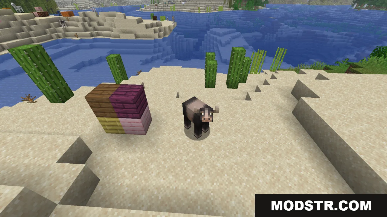 Dark cow variant standing on sand near cacti and colorful wooden blocks