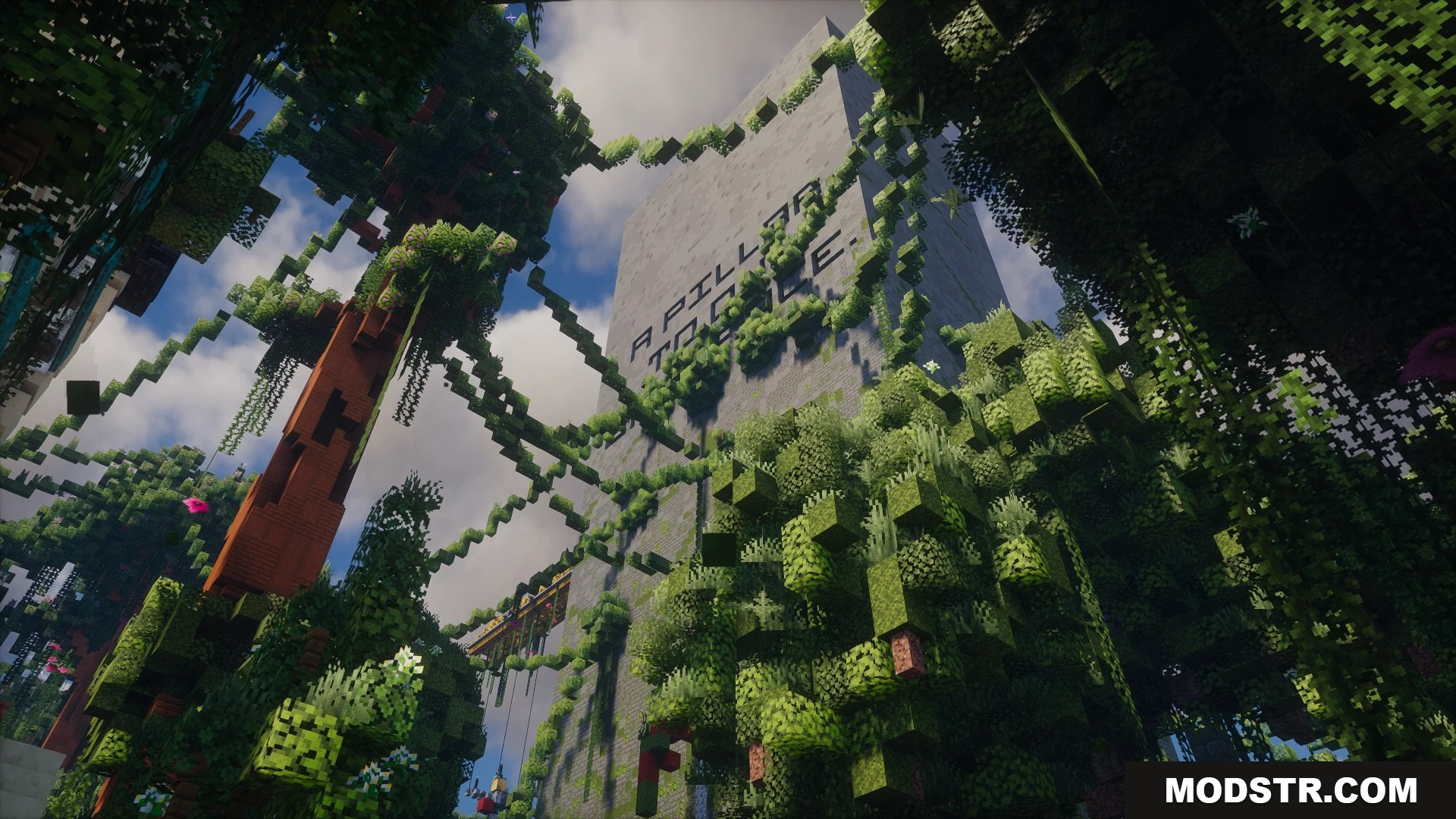 Looking up at a massive overgrown pillar structure with hanging vines