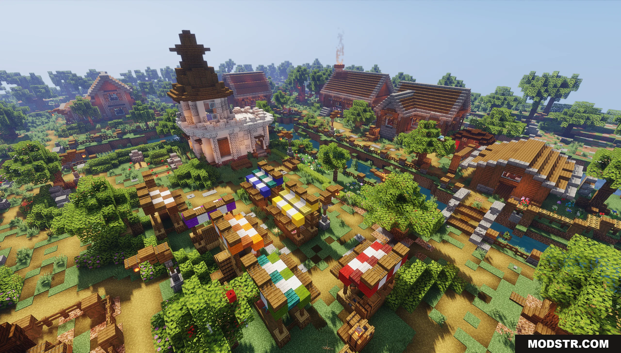 An aerial view of a Minecraft village with a market and stone tower