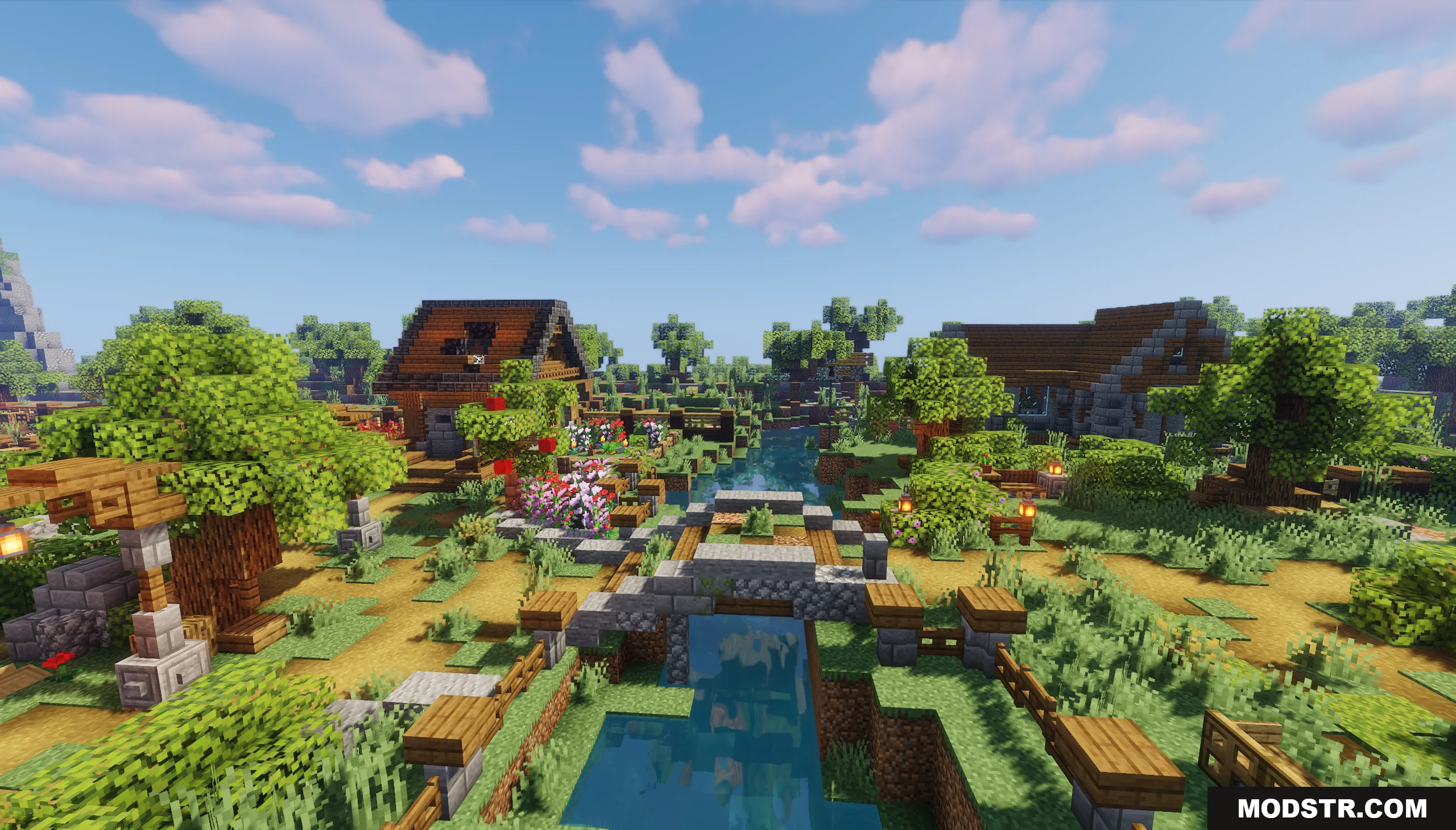 A stone bridge crosses a river in a lush Minecraft village landscape