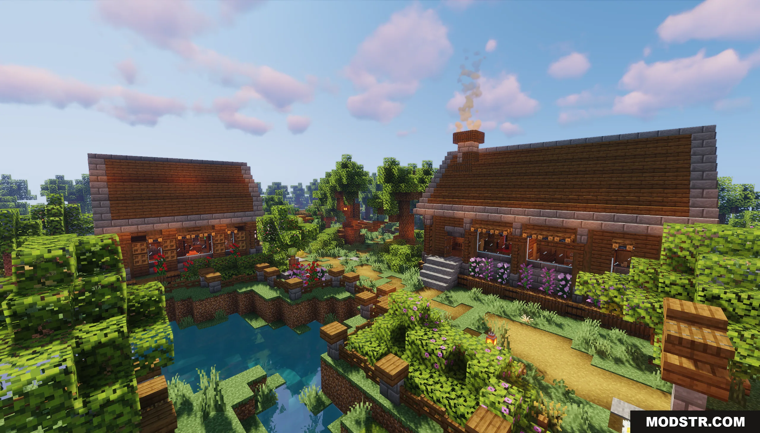 Cozy wooden houses with smoking chimneys next to a small garden pond