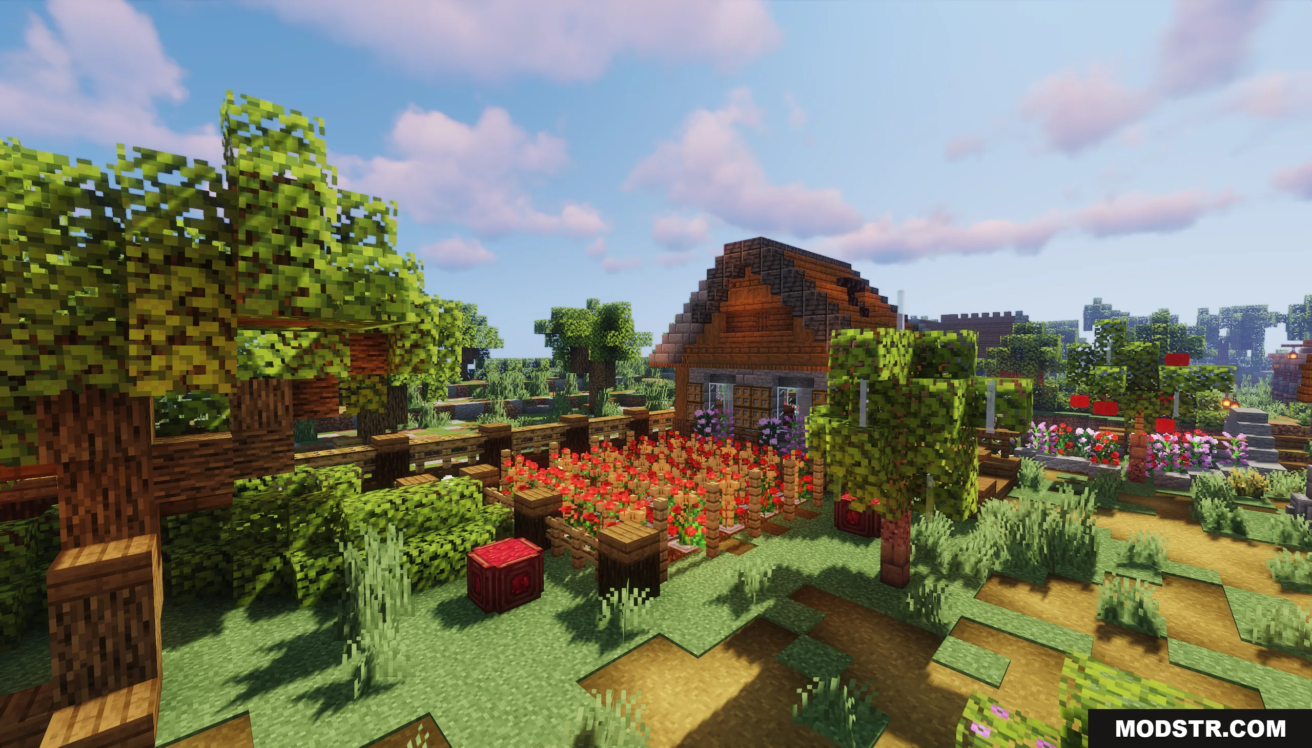 A cozy wooden house with a red flower garden surrounded by green trees