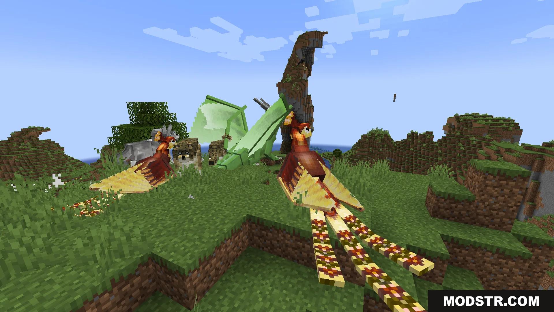 Two phoenixes and a green dragon resting on a grassy hill in Minecraft