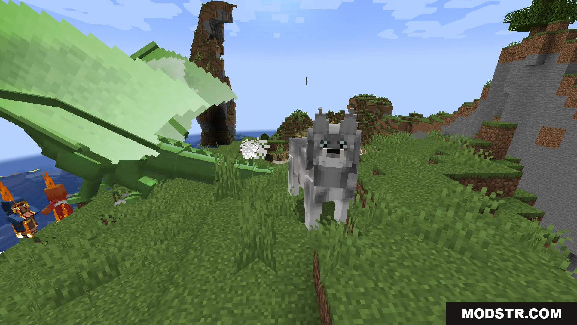 A large green dragon and a grey wolf standing on a grassy hill