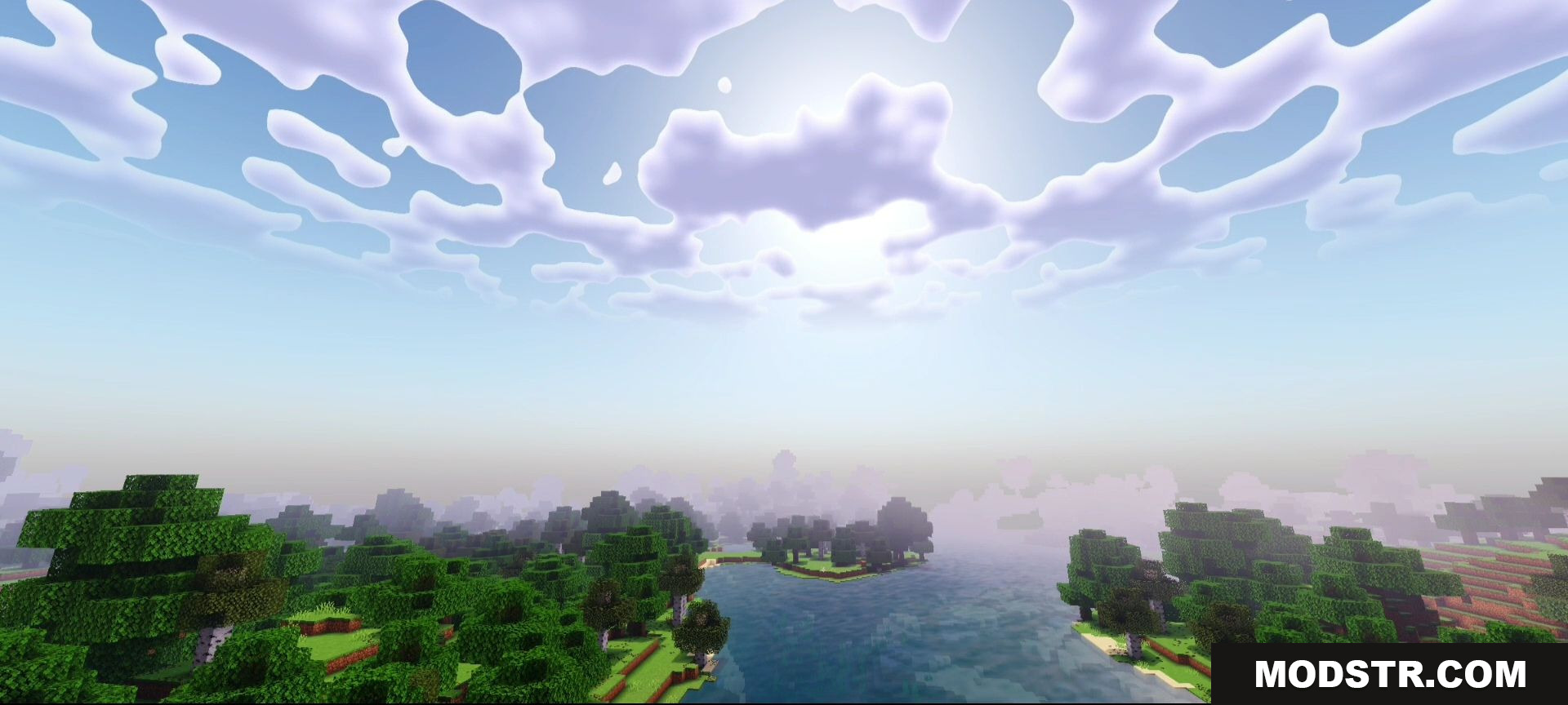 A scenic view of a river and forest under a cloudy sky