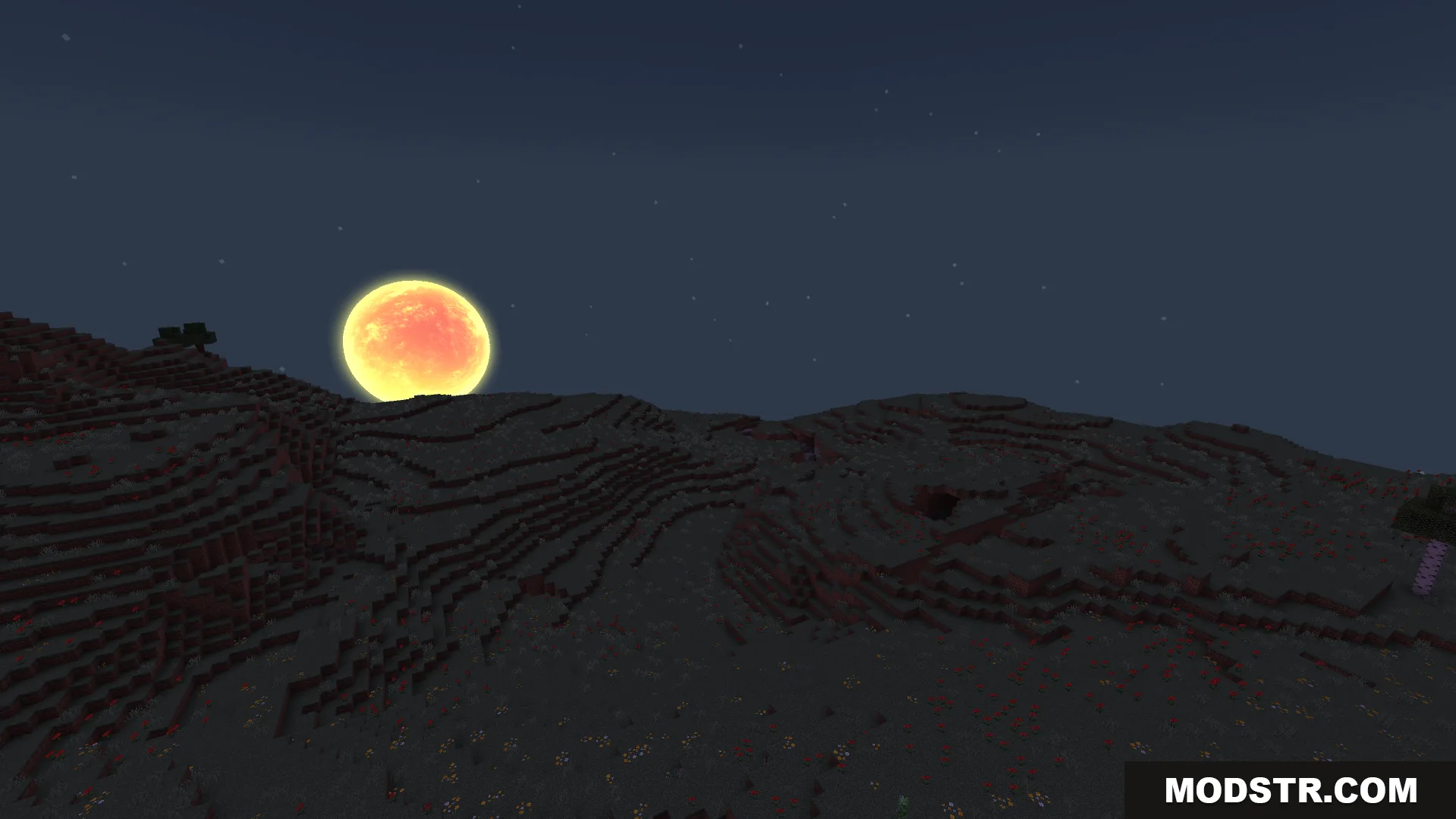 Large glowing orange moon rising over dark hills under a starry sky