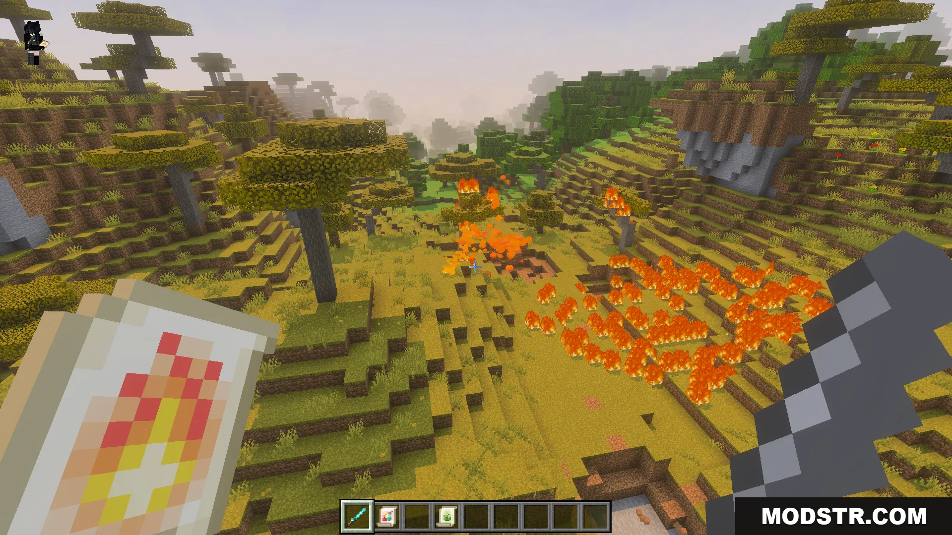 Player holding a fire scroll while standing in a burning savanna biome