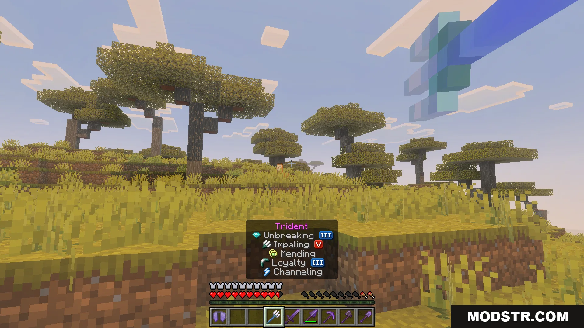 OP Loot Kit Addon Screenshot 10 Player holding an enchanted trident with powerful enchantments in a savanna biome