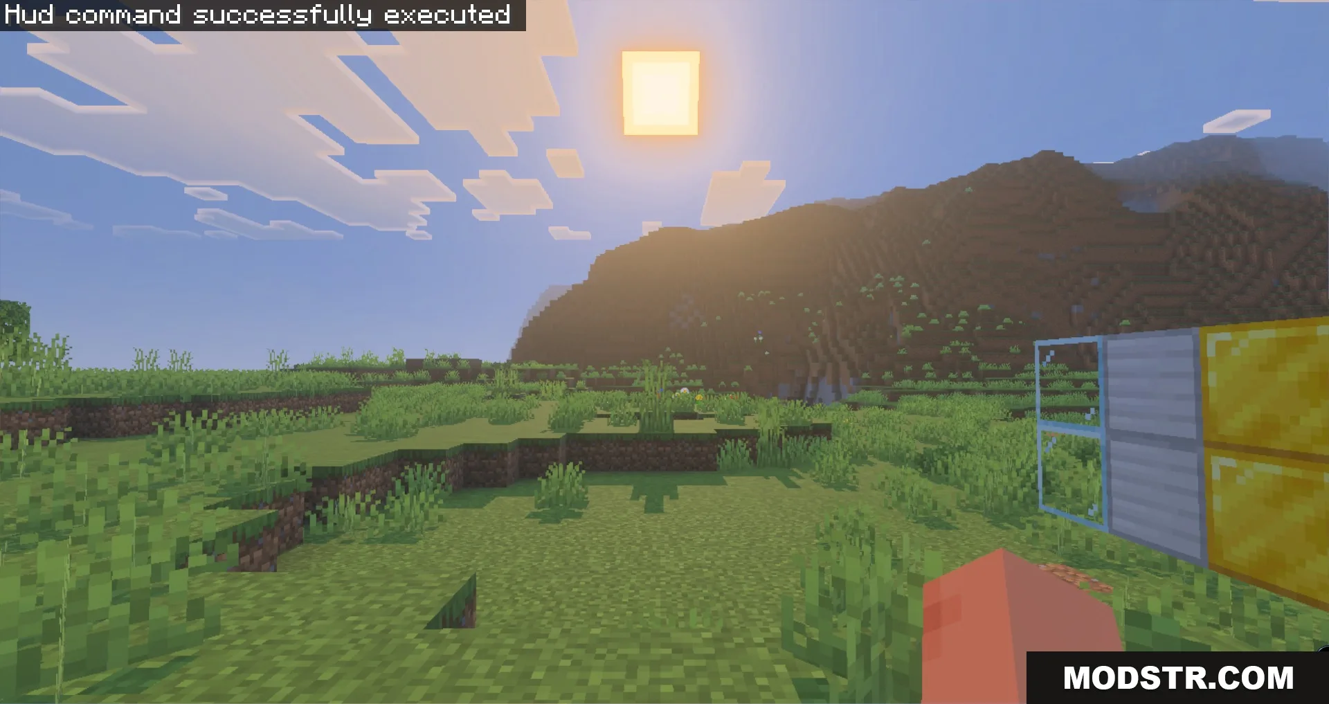 Bright sun shining over a grassy field with iron and gold blocks