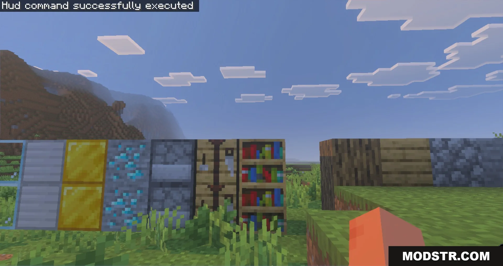 A row of various Minecraft blocks and ores displayed in an open field