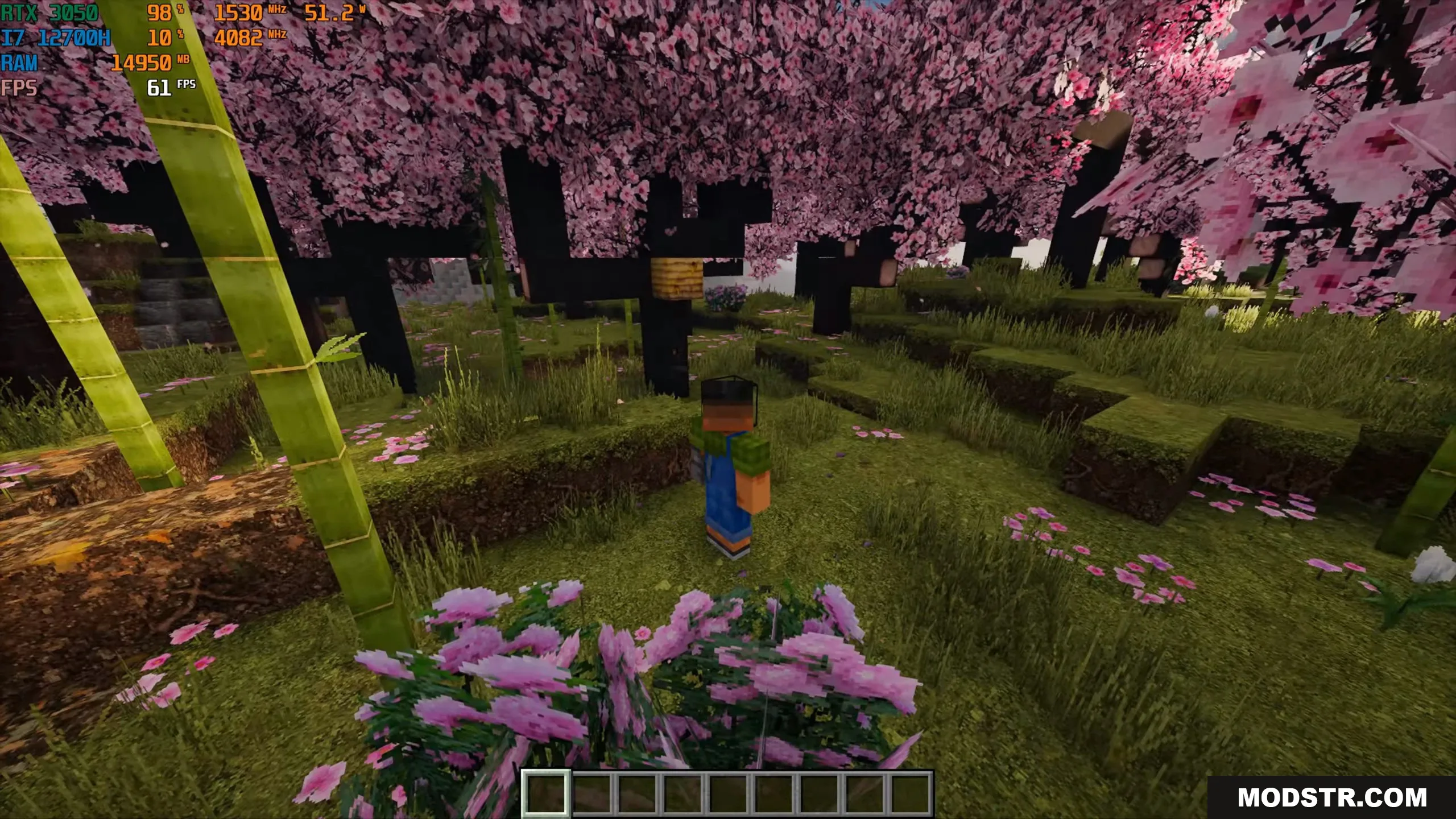 Player character standing in a lush cherry blossom biome with realistic bamboo