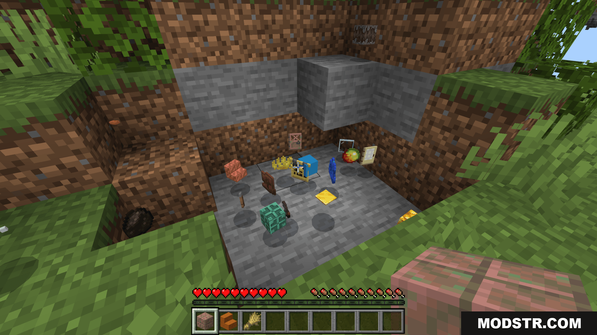 Various random items scattered on the ground in a dug area
