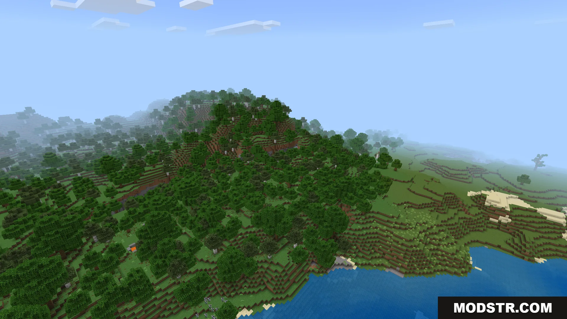 A dense forest covering a hillside overlooking a vast blue ocean in Minecraft