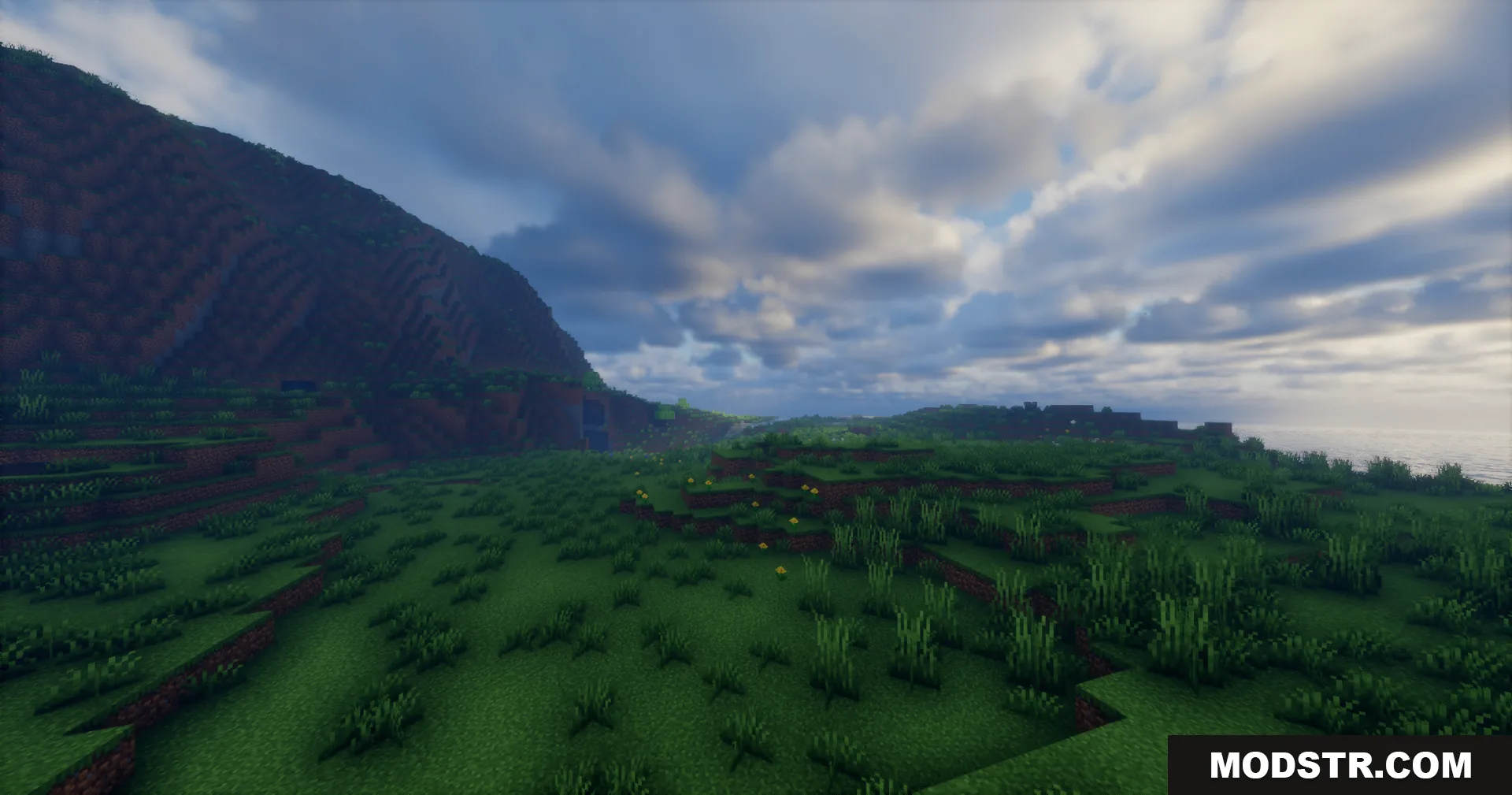 Rrtt217 S Hdr Mod Screenshot 13 Wide Minecraft landscape featuring green hills and a realistic cloudy sky with enhanced lighting