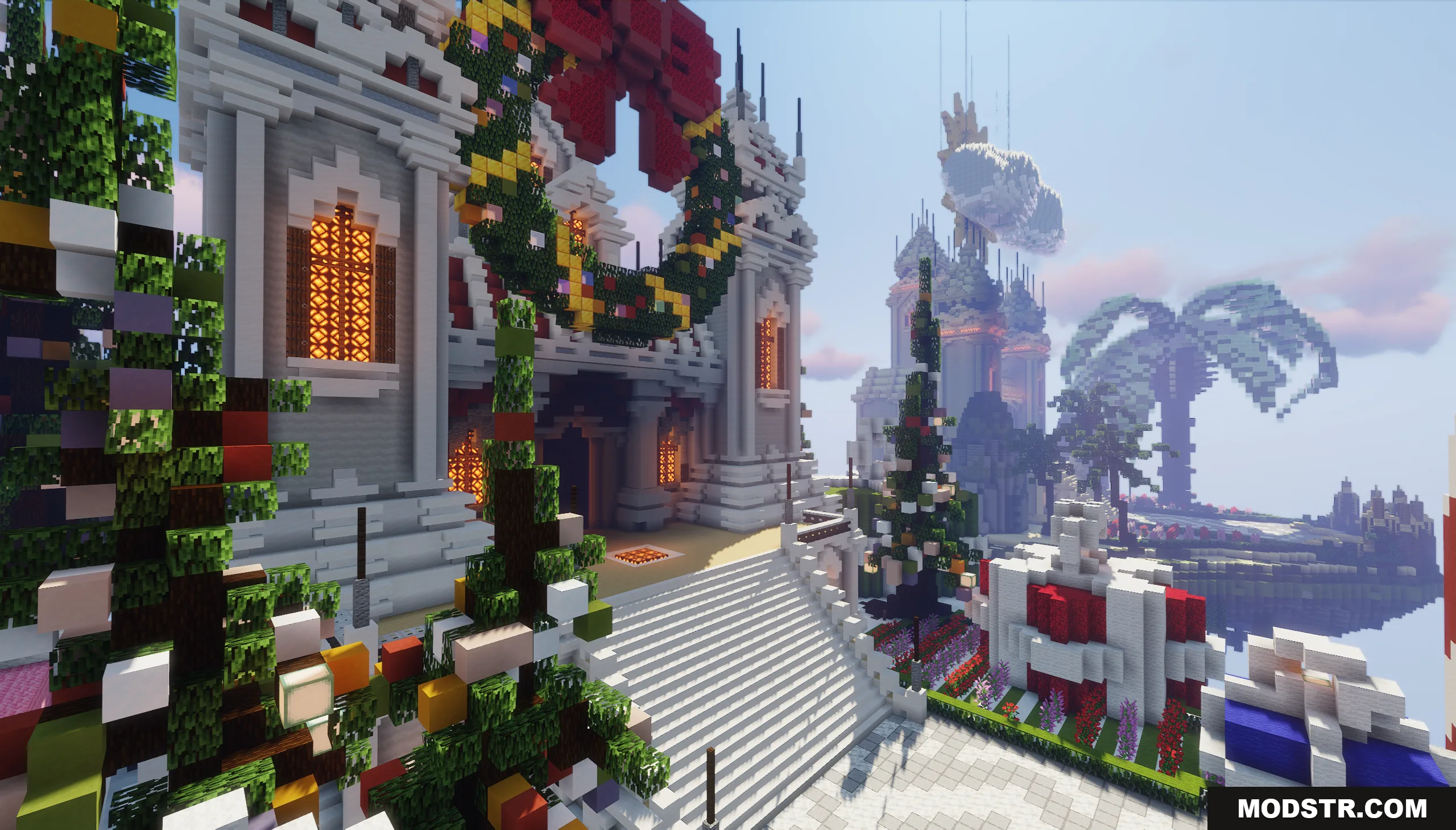 A festive lobby decorated with a giant wreath and colorful Christmas trees